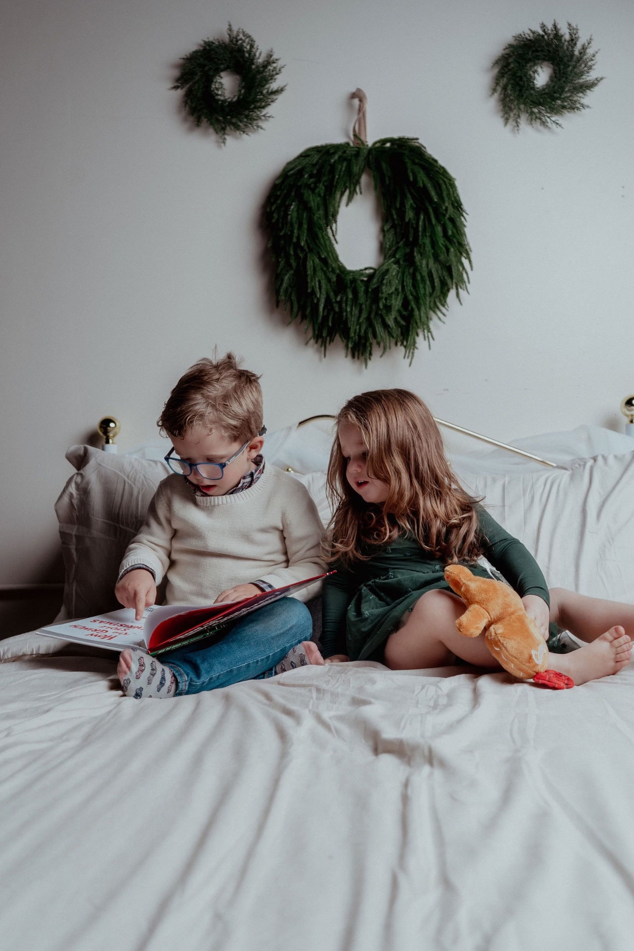 Siblings reading on the bed